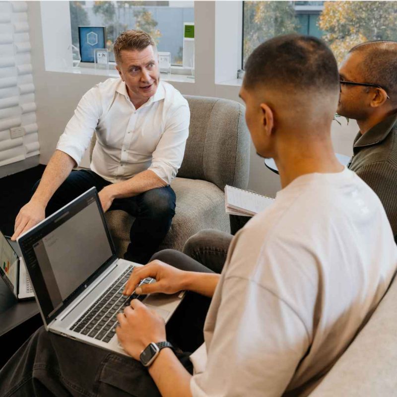 KMTech consultant discussing managed IT support with two colleagues
